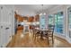 Eat-in kitchen features wood cabinetry, stainless appliances, hardwood floors, and large windows at 2723 Cameron Pond Dr, Cary, NC 27519
