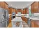 Spacious kitchen with stainless steel appliances, custom wood cabinets, and island at 2723 Cameron Pond Dr, Cary, NC 27519