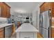 Spacious kitchen features a central island, stainless steel appliances, and warm wood cabinetry at 2723 Cameron Pond Dr, Cary, NC 27519