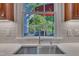 Kitchen sink features a stainless steel faucet, bright window, and marble counter tops at 2723 Cameron Pond Dr, Cary, NC 27519
