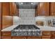 Gourmet kitchen boasts a professional Thor gas range and stylish tile backsplash at 2723 Cameron Pond Dr, Cary, NC 27519
