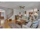 Inviting living room featuring hardwood floors, a comfortable seating area, and seamless flow to other living spaces at 2723 Cameron Pond Dr, Cary, NC 27519