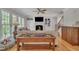 Bright living room with fireplace, hardwood floors, and staircase access at 2723 Cameron Pond Dr, Cary, NC 27519
