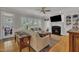 Cozy living room featuring a fireplace, hardwood floors, and a view of the outdoors at 2723 Cameron Pond Dr, Cary, NC 27519
