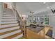 Elegant living room featuring hardwood floors, a comfortable seating area, and a staircase at 2723 Cameron Pond Dr, Cary, NC 27519