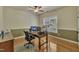 Bright home office featuring hardwood floors, a ceiling fan, large window and a desk at 2723 Cameron Pond Dr, Cary, NC 27519