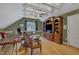 Well-lit upstairs office features wood floors, ceiling fan, and a large entertainment center at 2723 Cameron Pond Dr, Cary, NC 27519