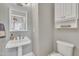 Charming powder room features a pedestal sink, mirror, and decorative accents at 2723 Cameron Pond Dr, Cary, NC 27519