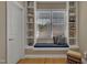 Reading nook with bookshelves, a cushioned bench seat, and a large window for natural light at 2723 Cameron Pond Dr, Cary, NC 27519