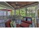 Cozy screened porch with comfortable seating, ceiling fan, and views of the outdoors at 2723 Cameron Pond Dr, Cary, NC 27519