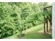 Landscaped backyard with lush greenery, complemented by a charming tree, enhancing the outdoor living experience at 273 Scarlet Tanager Cir, Holly Springs, NC 27540