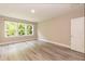 Basement bedroom with closet, large window, and new floors at 273 Scarlet Tanager Cir, Holly Springs, NC 27540