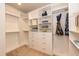 Organized walk-in closet with built-in shelving, drawers, and hanging rods for ample storage at 273 Scarlet Tanager Cir, Holly Springs, NC 27540