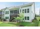 Exterior view of the home showcasing back screened in porch with staircase, and lower patio at 273 Scarlet Tanager Cir, Holly Springs, NC 27540