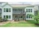 Exterior view of the home showcasing back screened in porch with staircase, and lower patio at 273 Scarlet Tanager Cir, Holly Springs, NC 27540