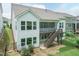 Exterior view of the home showcasing back screened in porch with staircase, and lower patio at 273 Scarlet Tanager Cir, Holly Springs, NC 27540