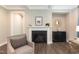 Elegant fireplace with a white mantel, decorative accents, and comfortable seating in a cozy living area at 273 Scarlet Tanager Cir, Holly Springs, NC 27540