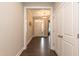 Inviting foyer with hardwood floors, neutral paint, a bright front door, and convenient coat closet at 273 Scarlet Tanager Cir, Holly Springs, NC 27540