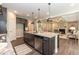 Kitchen island with granite countertops, stainless steel appliances, and open view to living room at 273 Scarlet Tanager Cir, Holly Springs, NC 27540