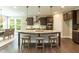 Kitchen island with granite countertop, stainless steel appliances, and seating at 273 Scarlet Tanager Cir, Holly Springs, NC 27540