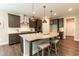 Kitchen island with granite countertop, seating, stainless steel appliances and white backsplash at 273 Scarlet Tanager Cir, Holly Springs, NC 27540