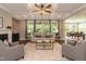 Spacious living room featuring coffered ceilings, a fireplace, and large windows with natural light at 273 Scarlet Tanager Cir, Holly Springs, NC 27540