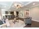 Open-concept living area with modern furnishings, hardwood floors, and seamless access to the kitchen at 273 Scarlet Tanager Cir, Holly Springs, NC 27540
