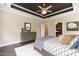 Main bedroom featuring tray ceiling, dresser, bedside tables and serene decor at 273 Scarlet Tanager Cir, Holly Springs, NC 27540