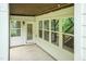 Covered patio featuring a door, large windows, and string lights, overlooking the backyard at 273 Scarlet Tanager Cir, Holly Springs, NC 27540