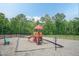 Neighborhood playground with a climbing structure and a bench providing a safe and fun recreational area at 273 Scarlet Tanager Cir, Holly Springs, NC 27540
