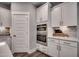 Kitchen area features stainless steel appliances, white cabinetry, and modern fixtures at 3004 Dog Rose Dr # 309, Durham, NC 27703