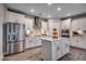 Spacious kitchen with stainless steel appliances, island, and sleek white cabinetry at 3004 Dog Rose Dr # 309, Durham, NC 27703