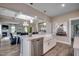 Open kitchen layout with a large island, stainless steel appliances, and views of the dining and living areas at 3004 Dog Rose Dr # 309, Durham, NC 27703
