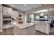 Bright kitchen showcasing white cabinets, stainless appliances, and a seamless view into the living area at 3004 Dog Rose Dr # 309, Durham, NC 27703