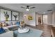 Bright living room with gray sofa, blue rug, and modern artwork on the wall at 3004 Dog Rose Dr # 309, Durham, NC 27703