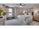 Bright main bedroom with large window, accent pillows and neutral décor at 3004 Dog Rose Dr # 309, Durham, NC 27703
