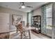 Home office with a rustic wooden desk, stylish decor, and natural light from the windows at 3004 Dog Rose Dr # 309, Durham, NC 27703