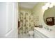 Bright bathroom with a leafy patterned shower curtain and vanity at 320 Delvin Lane Ln, Hillsborough, NC 27278