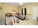 Well-lit bedroom with two beds, carpet, ceiling fan, and a window at 320 Delvin Lane Ln, Hillsborough, NC 27278