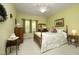 Cozy bedroom featuring wood floors, a ceiling fan, and a large window at 320 Delvin Lane Ln, Hillsborough, NC 27278