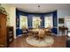 Bright dining room with hardwood floors, colorful walls and large windows with sheer white curtains at 320 Delvin Lane Ln, Hillsborough, NC 27278