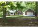 Beautiful brick home with an attached garage surrounded by lush trees and a meticulously kept lawn at 320 Delvin Lane Ln, Hillsborough, NC 27278