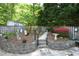 Well-maintained garden with stone retaining walls, flowers, and decorative elements at 320 Delvin Lane Ln, Hillsborough, NC 27278