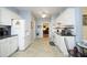 Eat-in kitchen with ample counter space, white cabinetry, and modern appliances with views of other living spaces at 320 Delvin Lane Ln, Hillsborough, NC 27278