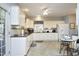 Bright kitchen boasts white cabinets, modern appliances, and a cozy breakfast nook with views to outside at 320 Delvin Lane Ln, Hillsborough, NC 27278