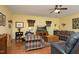 Spacious living room features hardwood floors, comfortable seating, and a ceiling fan with natural light at 320 Delvin Lane Ln, Hillsborough, NC 27278