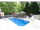Backyard pool surrounded by a patio with seating and lush landscaping at 320 Delvin Lane Ln, Hillsborough, NC 27278
