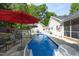 Outdoor pool with various seating and shade umbrellas in backyard at 320 Delvin Lane Ln, Hillsborough, NC 27278