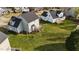 Aerial view of house showing the rear, deck, exterior color, and surrounding green lawn at 323 Windgate Dr, Clayton, NC 27527