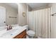 Cozy bathroom featuring a shower with patterned curtain and wooden vanity at 323 Windgate Dr, Clayton, NC 27527